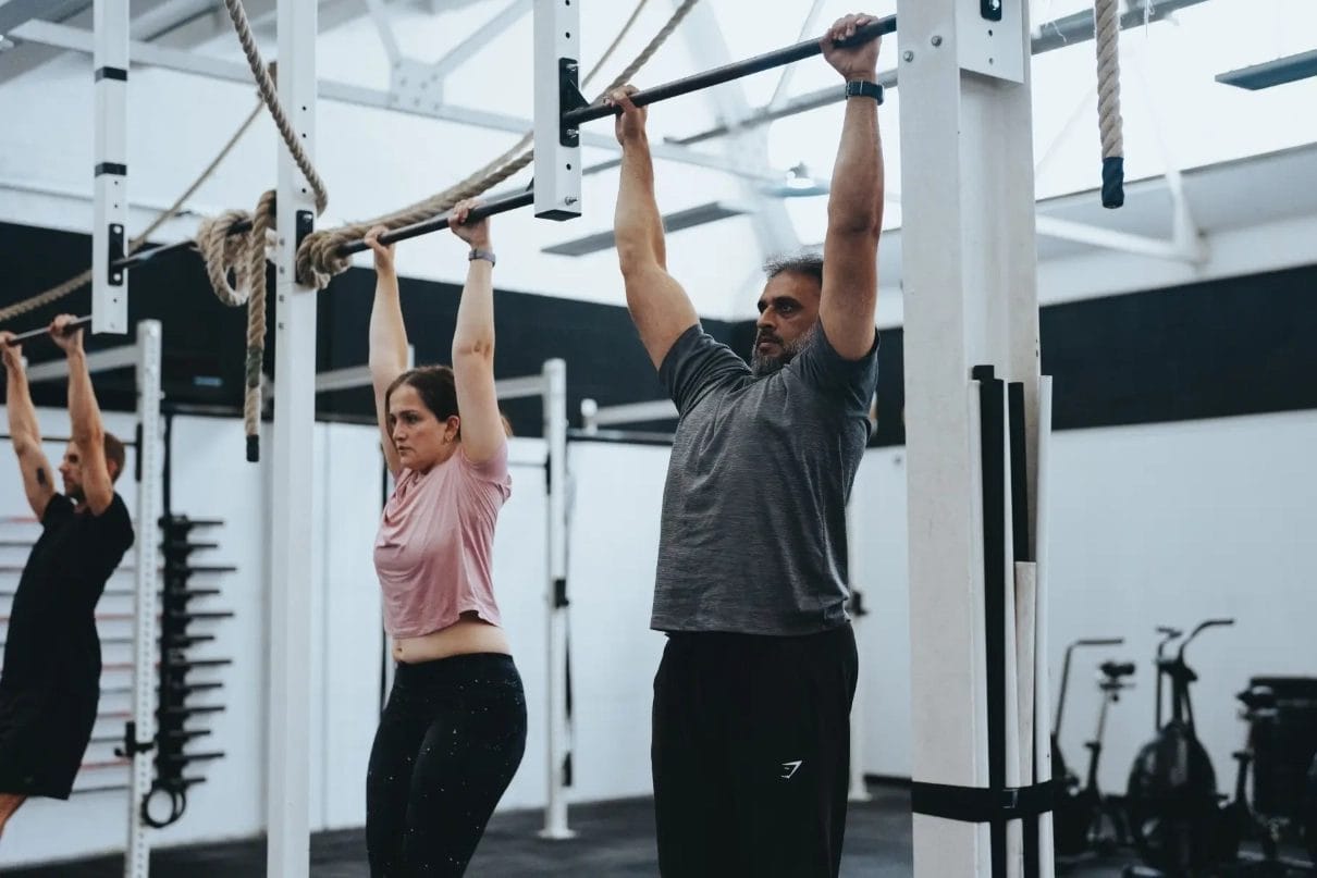 people hanging and exercising